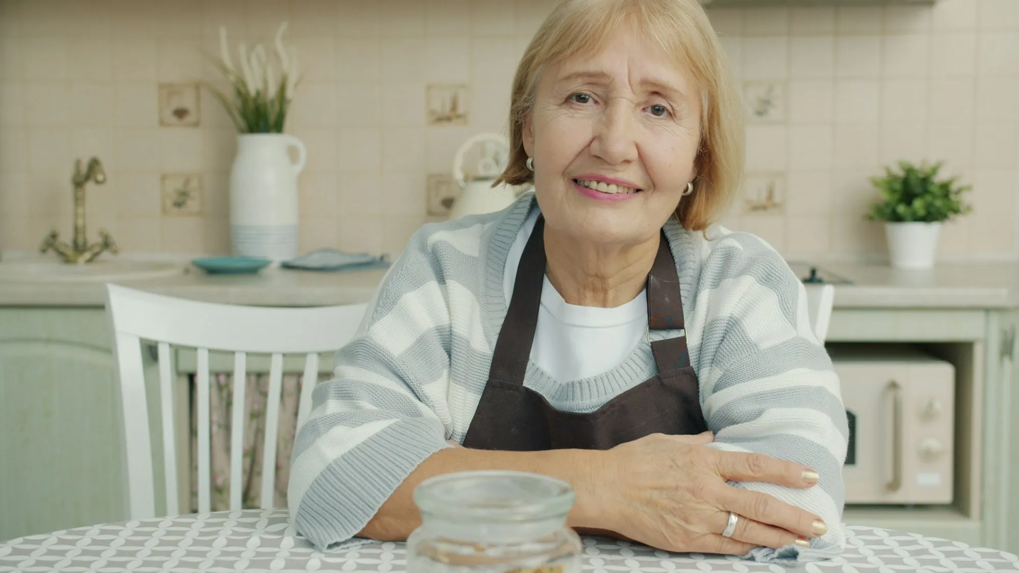 An older person and a visitor sitting together at home