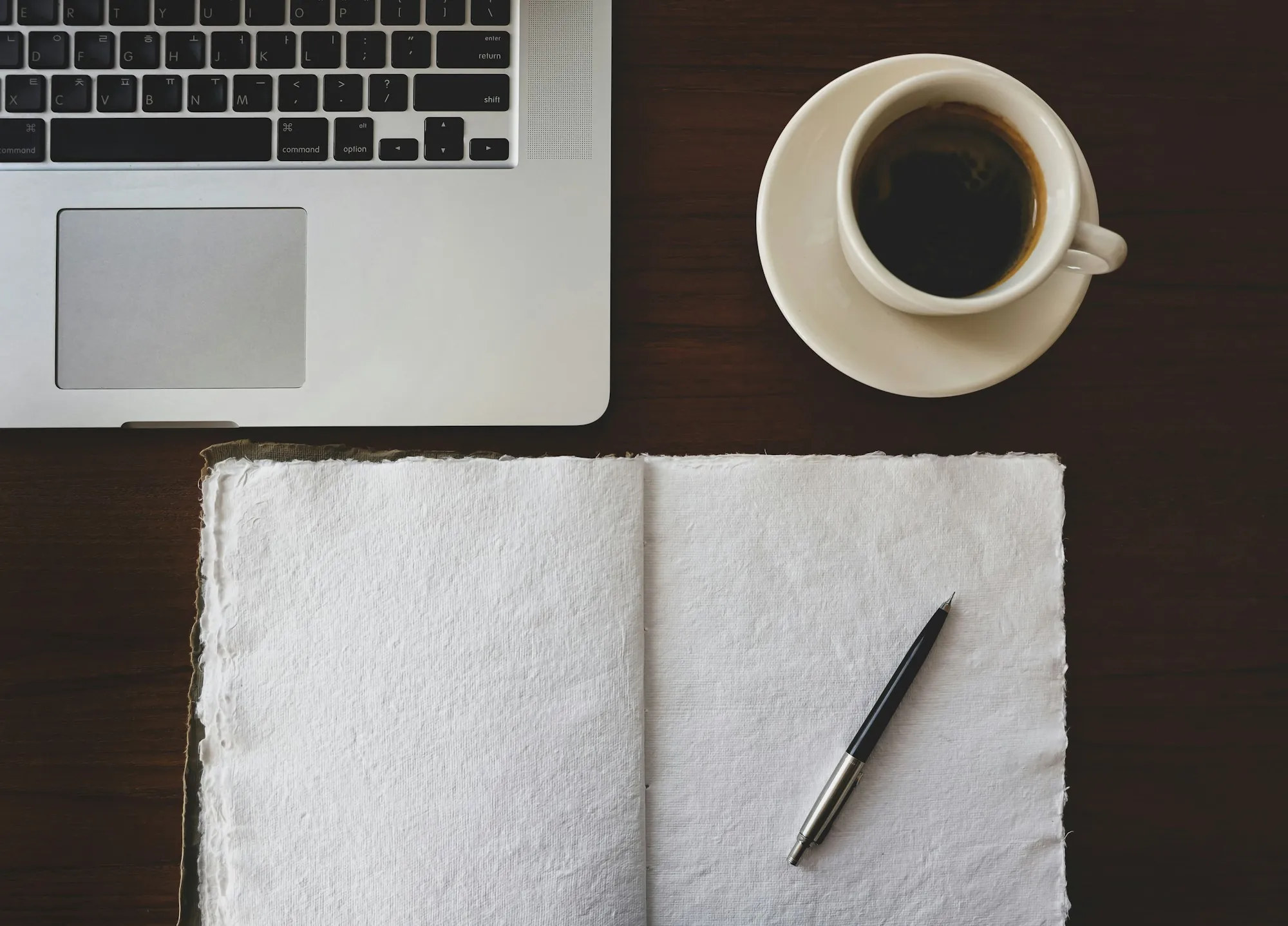 A notebook and a cup on a table