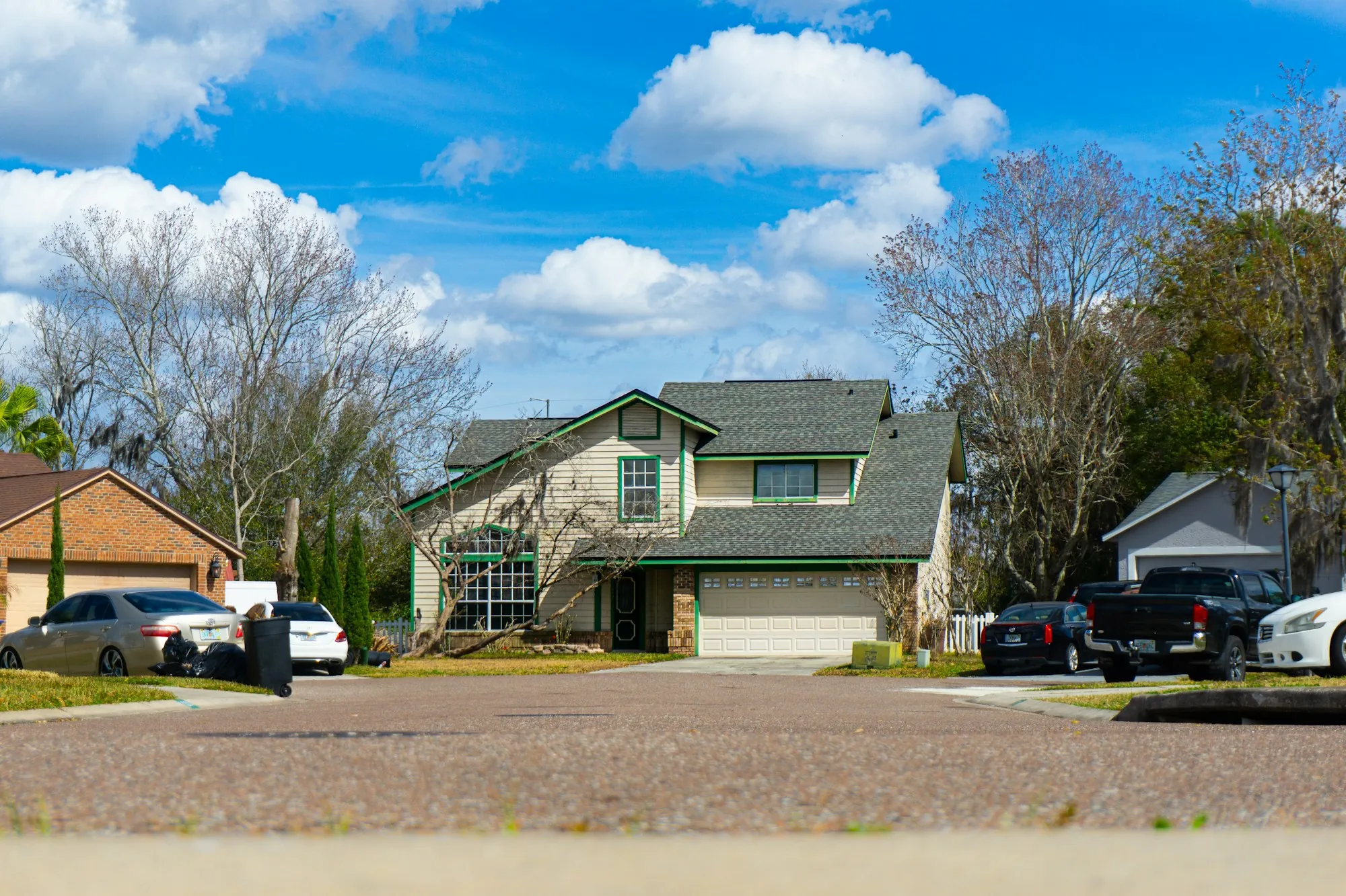 Suburban houses and driveways under a blue sky