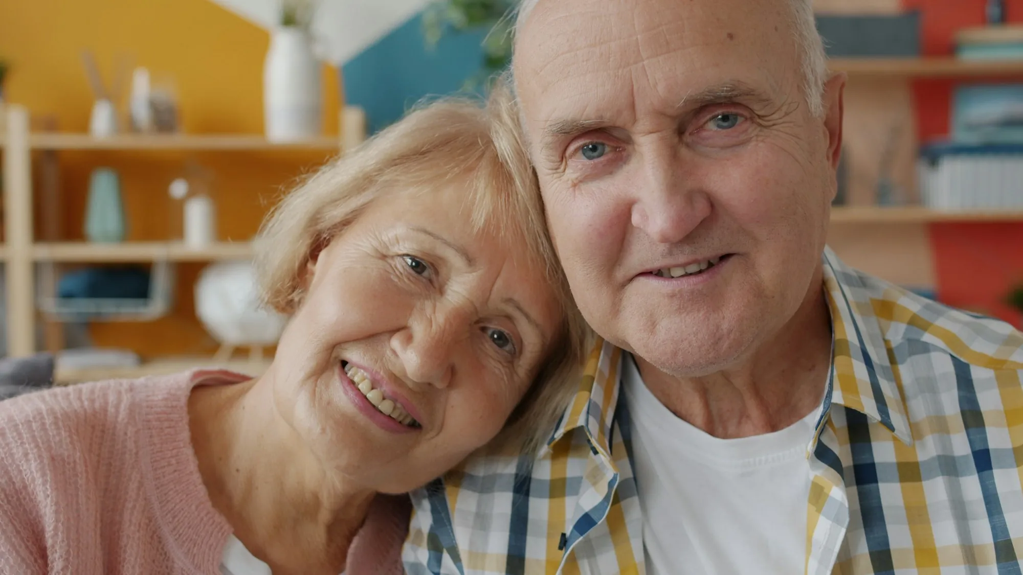 An older couple sitting together at home