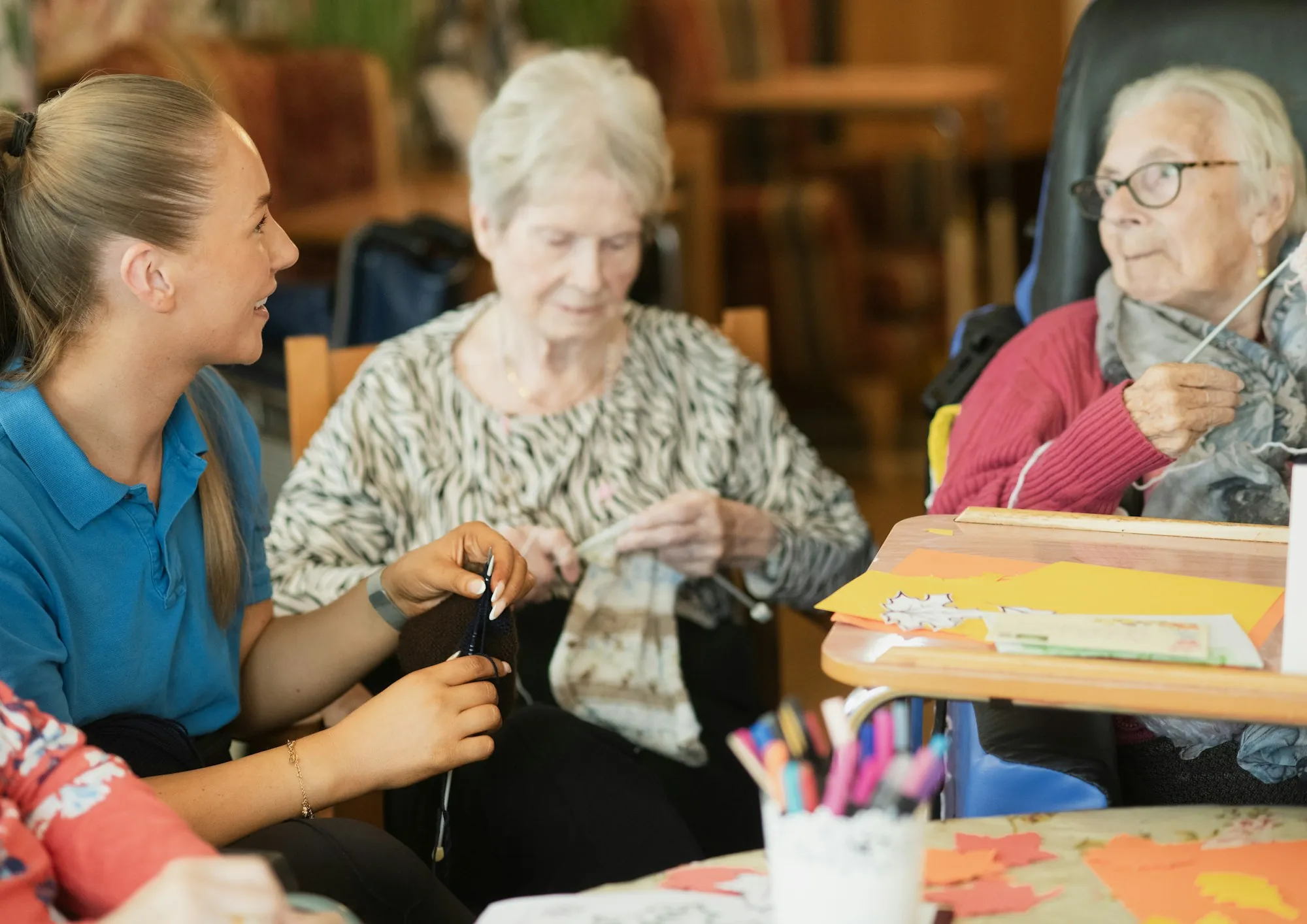 A care worker helping an older woman at home