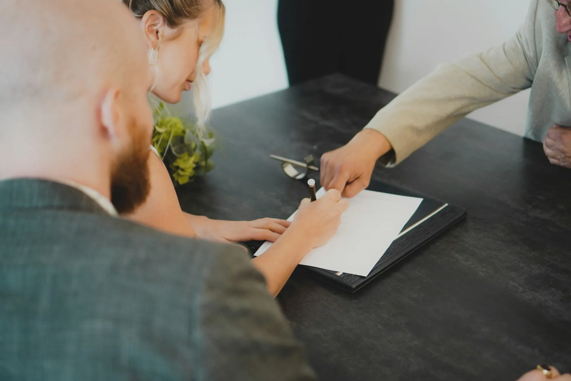 Two people going through paperwork at a table